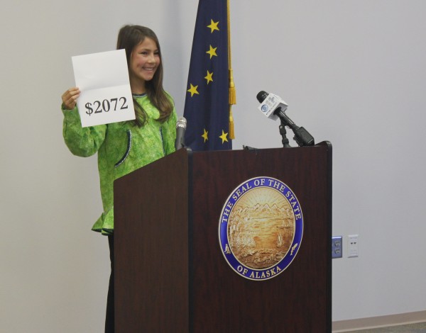 Palmer Jr. Middle School 7th grader, Shania Sommer, 12, announced the amount of the 2015 Permanent Fund Dividend. (Photo by Josh Edge, APRN - Anchorage)