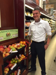 Stephen Longnecker stands beside the reduced price produce stand in Fred Meyer in Anchorage. (Hillman/KSKA)