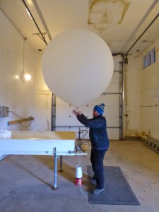 William Wells prepares a weather balloon for launch. (KUCB/John Ryan photo)