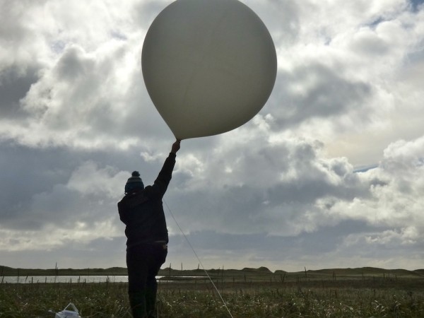 William Wells, about to launch a weather balloon on St. Paul Island, Alaska. (KUCB/John Ryan photo)