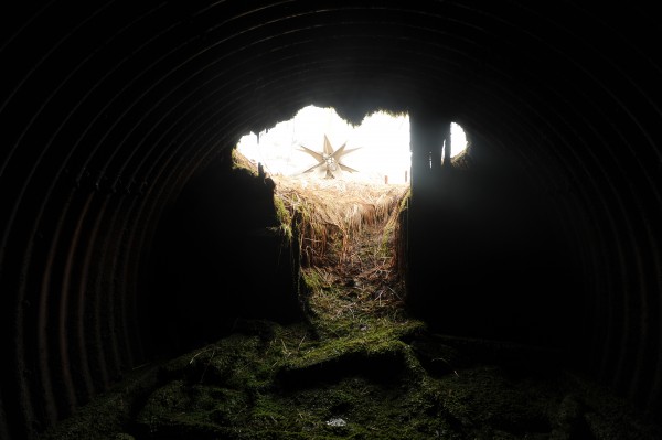 The World War II memorial constructed by the Japanese government honoring American and Japanese soldiers on Engineer Hill on Attu Island is visible from inside a buried Quonset Hut bunker. (Bob Hallinen / Alaska Dispatch News)