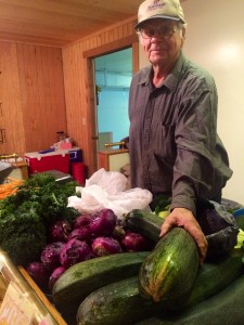 Shopper checks out locally grown vegetables. (Photo by Daysha Eaton/KBBI)