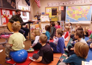 Music teacher James Baldwin sings with first and second graders. (Emily Files/KHNS)