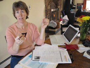 Victoria Cronquist shops for lower cost health insurance at her Anchorage home. She may drop coverage.