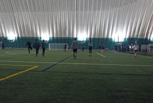 The UAA cross country running team warms up before practice at the Dome in Anchorage. (Photo by Josh Edge/APRN)