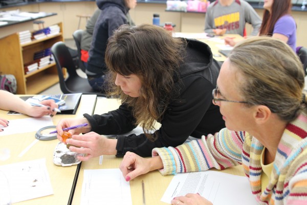 Teachers examine artificial moon and Mars soil at the Alaska Math and Science Conference, held at Sitka High School. (Brielle Schaeffer/KCAW photo)