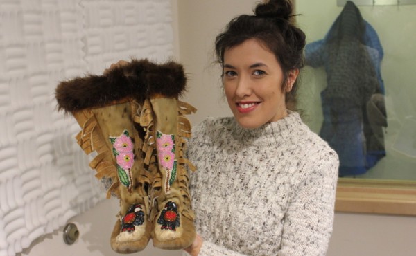 Crystal Nelson holds up a pair of moccasins passed down to her from her grandmother. (Photo by David Purdy/KTOO)