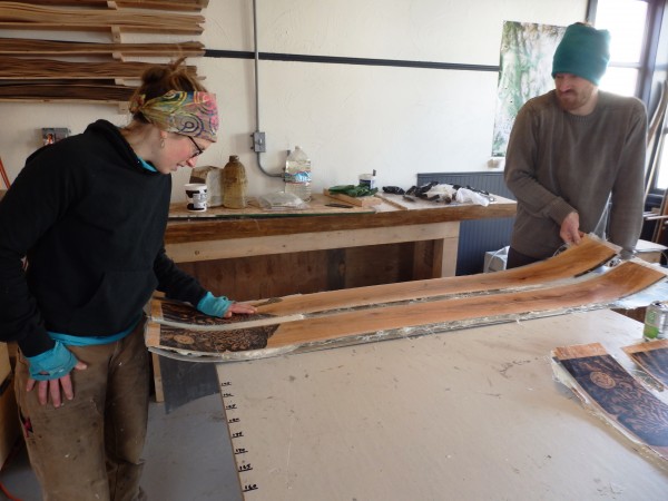 Lindsay Johnson and Graham Kraft examine a newly pressed pair of skis. (Emily Files/KHNS)
