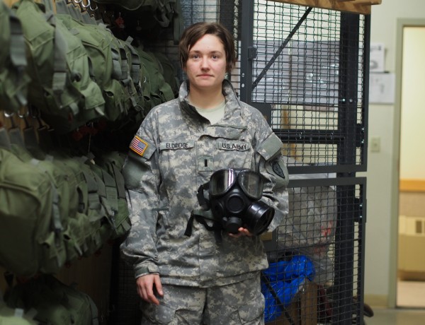 First Lieutenant Elizabeth Eldridge holding an M40 Protective Mask inside the NBC Cage at JBER. Photo: Zachariah Hughes.