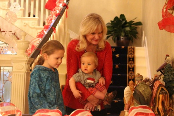 First lady Donna Walker shows her grandchildren the nativity set. (Photo by Elizabeth Jenkins/KTOO)