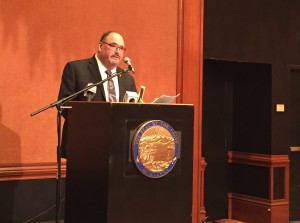 Commission Chair Greg Razo talks about the new report at the Captain Cook Hotel. (Hillman/KSKA)
