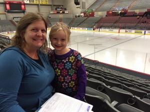 Tracy Peterson and her daughter apply for SNAP benefits during an event at the Sullivan Arena. Hillman/KSKA