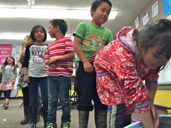 St. Paul students line up to stick their hands inside "blubber mitts" (Crisco-lined plastic bags) to learn how marine mammals stay warm in the icy Bering Sea. KUCB PHOTO/JOHN RYAN