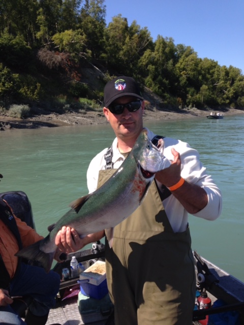 Staff Sergeant Joshua Schneiderman, a forward observer stationed with the 4th Brigade 25th Infantry Division, holding a silver salmon caught during a Wounded Warriors event.