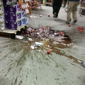Clerks at Save U More found some cleanup waiting for them after Sunday morning's quake. (Photo by Michael Rohrbacher ) 