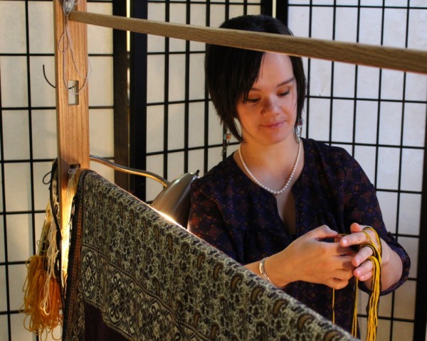 Keeping with tradition, Lily Hope covers her weaving. She won’t publicly share photos until the blanket is finished. (Photo by Elizabeth Jenkins/KTOO)