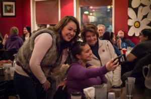 Senator Lisa Murkowski posing for a selfie with locals Naomi Jorgensen and Vanessa Connors at Nome’s Airport Pizza. (Photo: Mitch Borden/KNOM)
