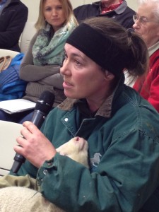 Large animal veterinarian Sabrieta Holland takes the mic with a lamb in her care. Photo: Ellen Lockyer/KSKA-Anchorage.