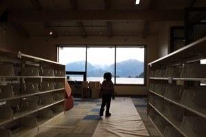 Shewa Bryner roams the shelves and tries out the view. (Emily Kwong/KCAW photo)