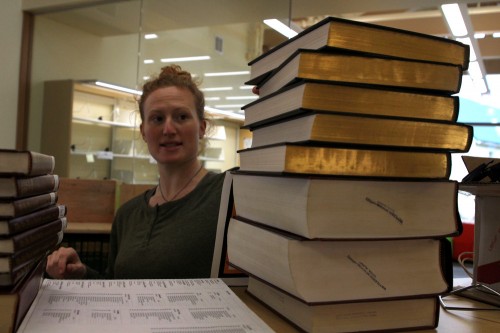 Librarian Brooke Schafer begins unpacking reference books. (Photo by Emily Kwong, KCAW - Sitka)
