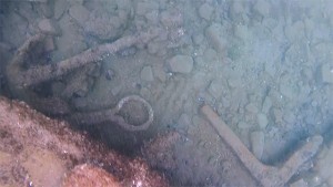 A small anchor; a chain plate, which held rigging used to tighten masts; and a iron knee, which was likely part of the ship's frame. Credit: NOAA