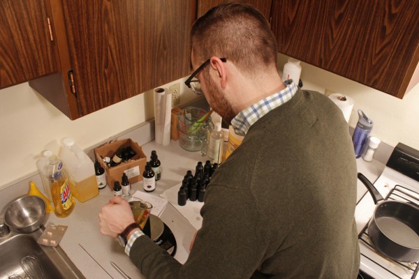 Kyle Reading prepares a batch of Flintlock beard oil. (Photo by Josh Edge/APRN)