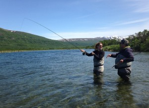 David Parks Jr. gives some casting tips to his client Sarah Pearl in the Kulik River at the Bristol Bay Guide Academy, June 2015. (Photo by Matt Martin/KDLG)