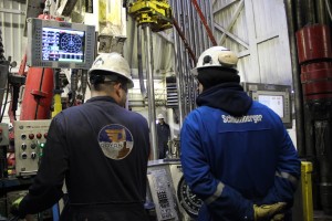 Two contractors monitor the drilling of an injection well at ConocoPhillips' CD5 drill site on the North Slope. Photo: Rachel Waldholz/APRN
