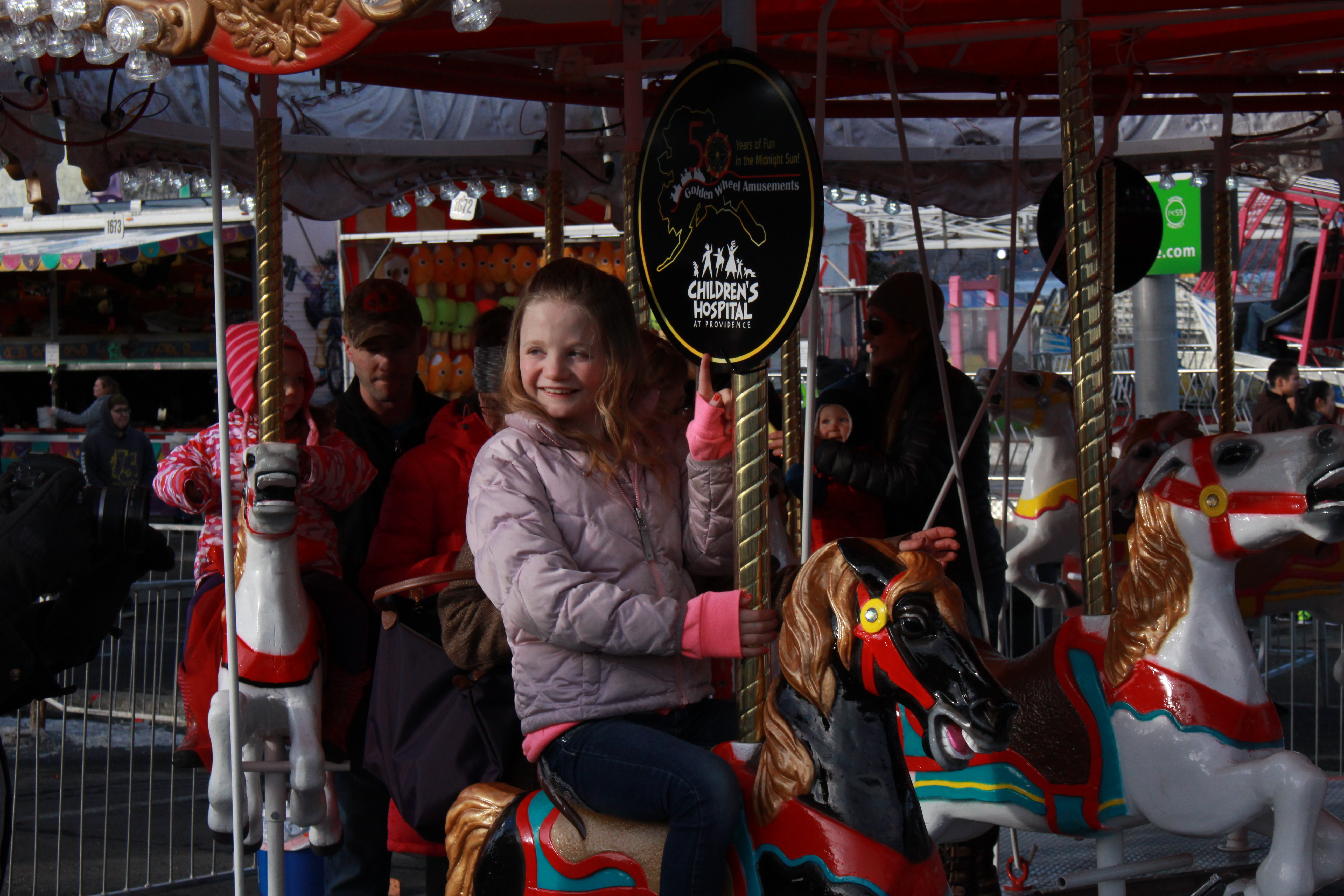 11-year-old Ashley Perry rides the Golden Carousel. Perry was the ceremonial ribbon-cutter. (Photo by Wesley Early, APRN - Anchorage)