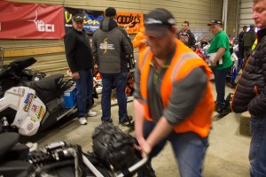 Volunteers help move machines around in the garage. (Photo: Emily Russell/KNOM)
