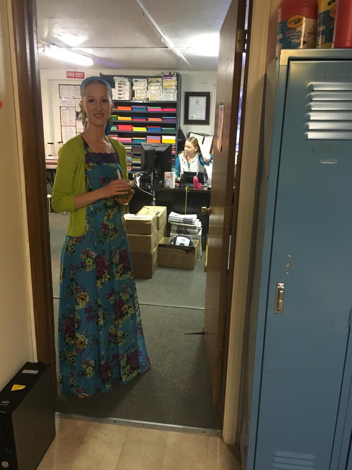 Arena White, a teacher at Kachemak Selo School, pauses in the doorway at the school's office (Photo by Daysha Eaton, KBBI - Homer)