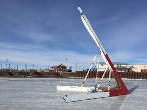 Kuskokwim Ice Classic tripod standing on the Kuskokwim River in front of Bethel. The top represents a story knife and the bottom legs represents kayaks. (Photo courtesy of Michell DeWitt.)