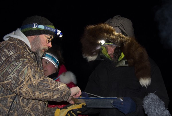 Nicholas Petit signing in for a short stop before heading back onto the trail. (Photo by Zachariah Hughes/KSKA)