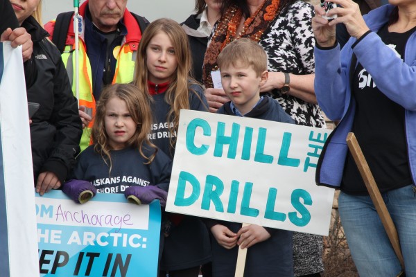 Molly, Penelope and Simon Whitlock, ages 5, 10 and 7, joined protesters opposed to offshore drilling outside the Bureau of Ocean Energy Management's public meeting in Anchorage on April 5, 2016. Photo: Rachel Waldholz/APRN