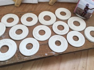 The medals, dry and ready for glaze. Photo credit: Becky King