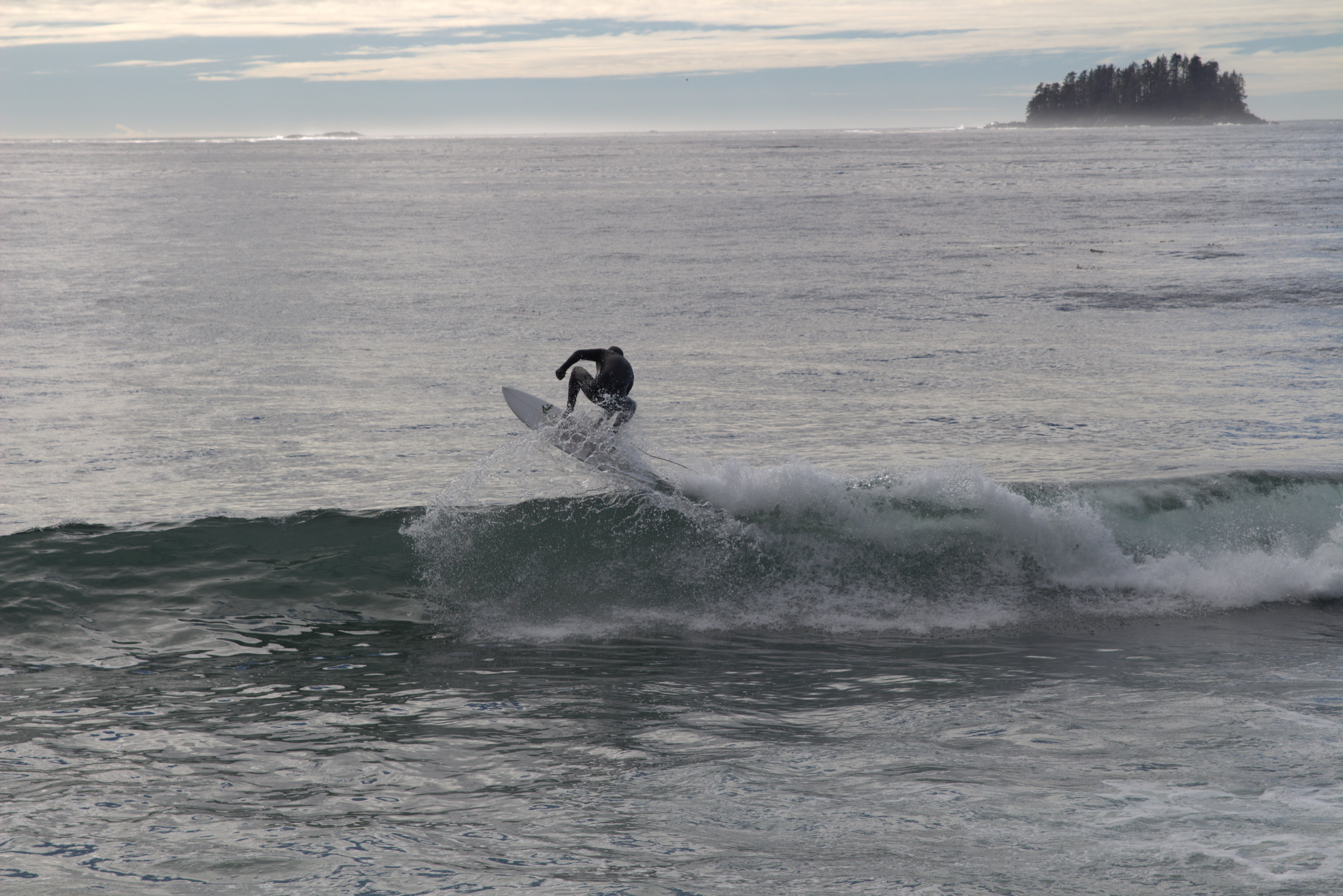 A surfer tucks a wave at Sandy Beach in Sitka. (Photo by Brielle Schaeffer,KCAW - Sitka)