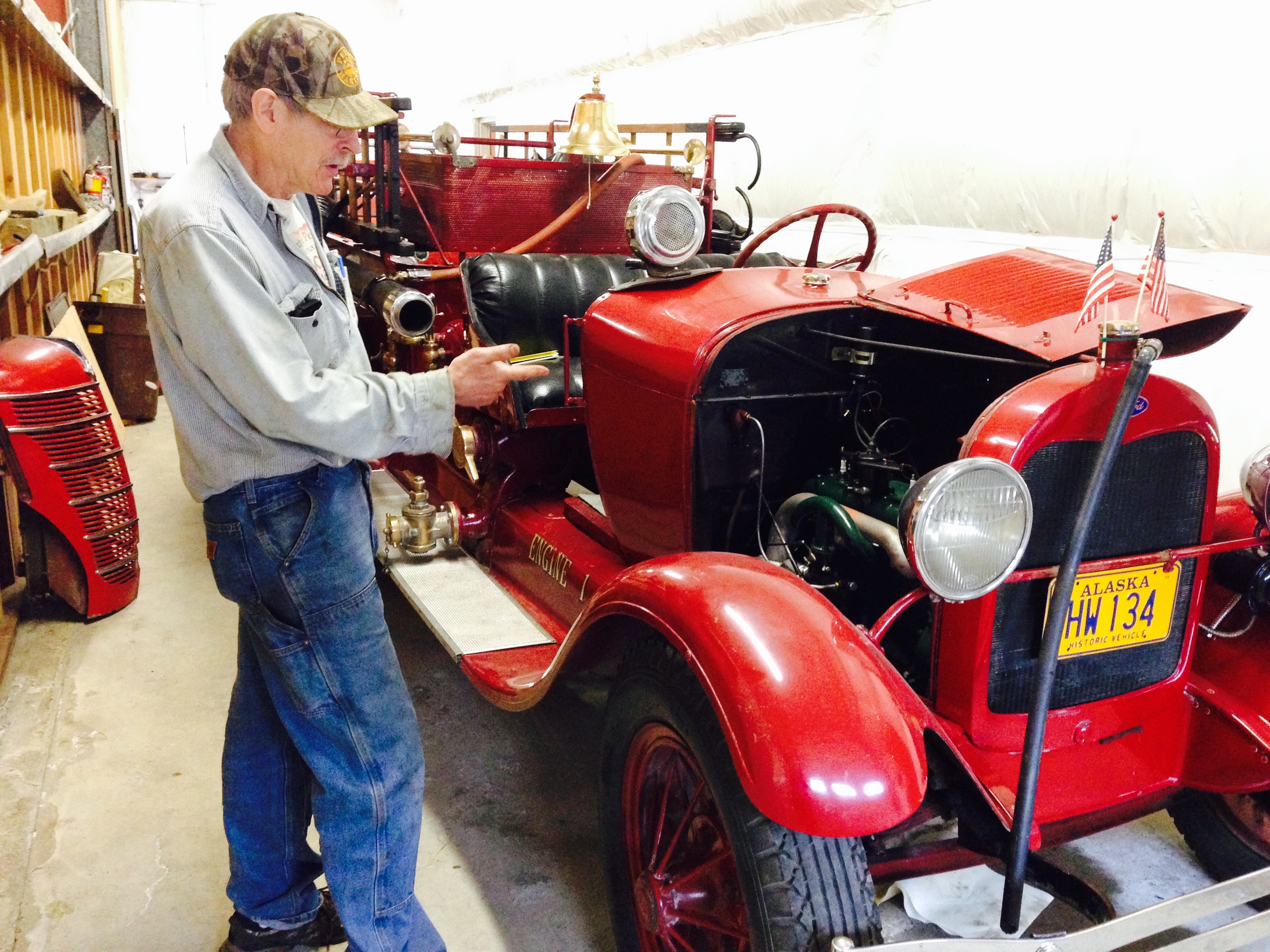 Jack Slaght points to the engine he overhauled in the 1928 Model A fire truck. (Photo by Angela Denning, KFSK - Petersburg)