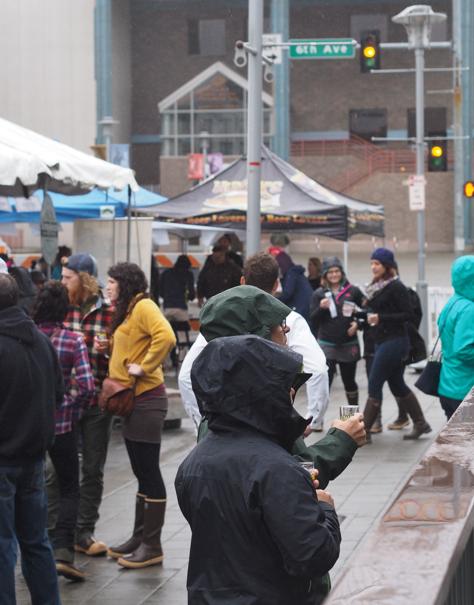Patrons at the Alaska Crafted Festival enduring the rain and wind during the Saturday event in downtown Anchorage. (Photo by Zachariah Hughes, Alaska Public Media - Anchorage)