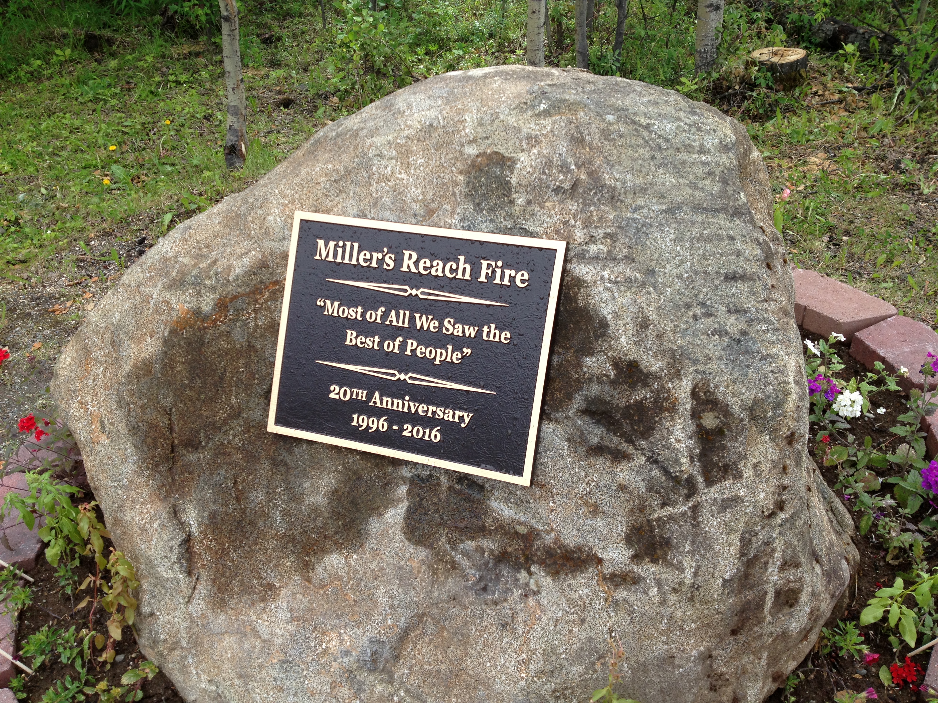 A bronze plaque set into a boulder in front of the West Lakes fire house in Big Lake recognizes the firefighters and community residents who helped fight the Miller's Reach fire twenty years ago. (Photo by Ellen Lockyer, Alaska Public Media - Anchorage)