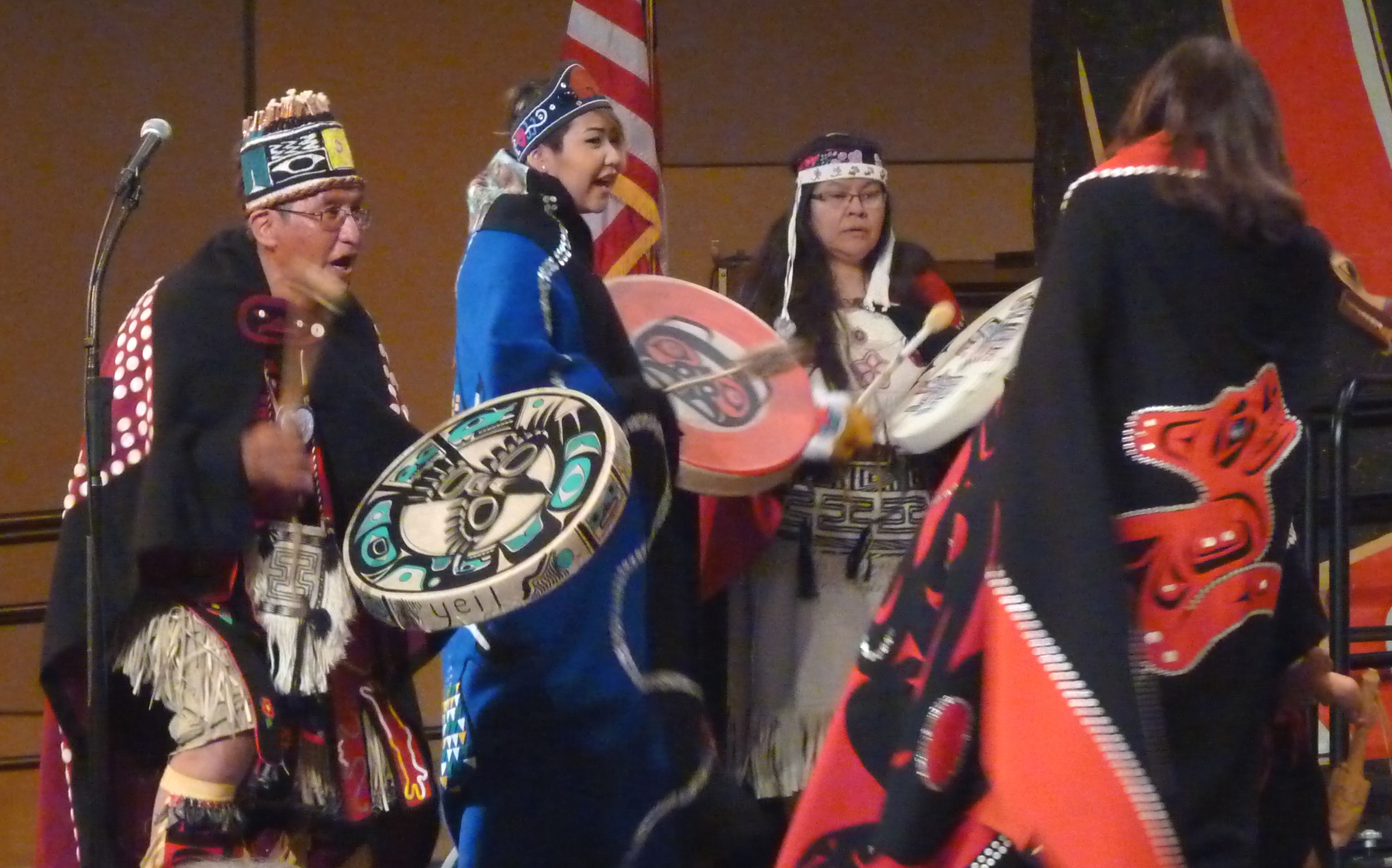 Taku Kwaan Dance Leader Wayne Carlick, left, and others drum as more than 30 people take the stage during Celebration 2016. The Atlin, British Columbia, group included relatives from Juneau.  (Photo by Ed Schoenfeld, CoastAlaska - Juneau)