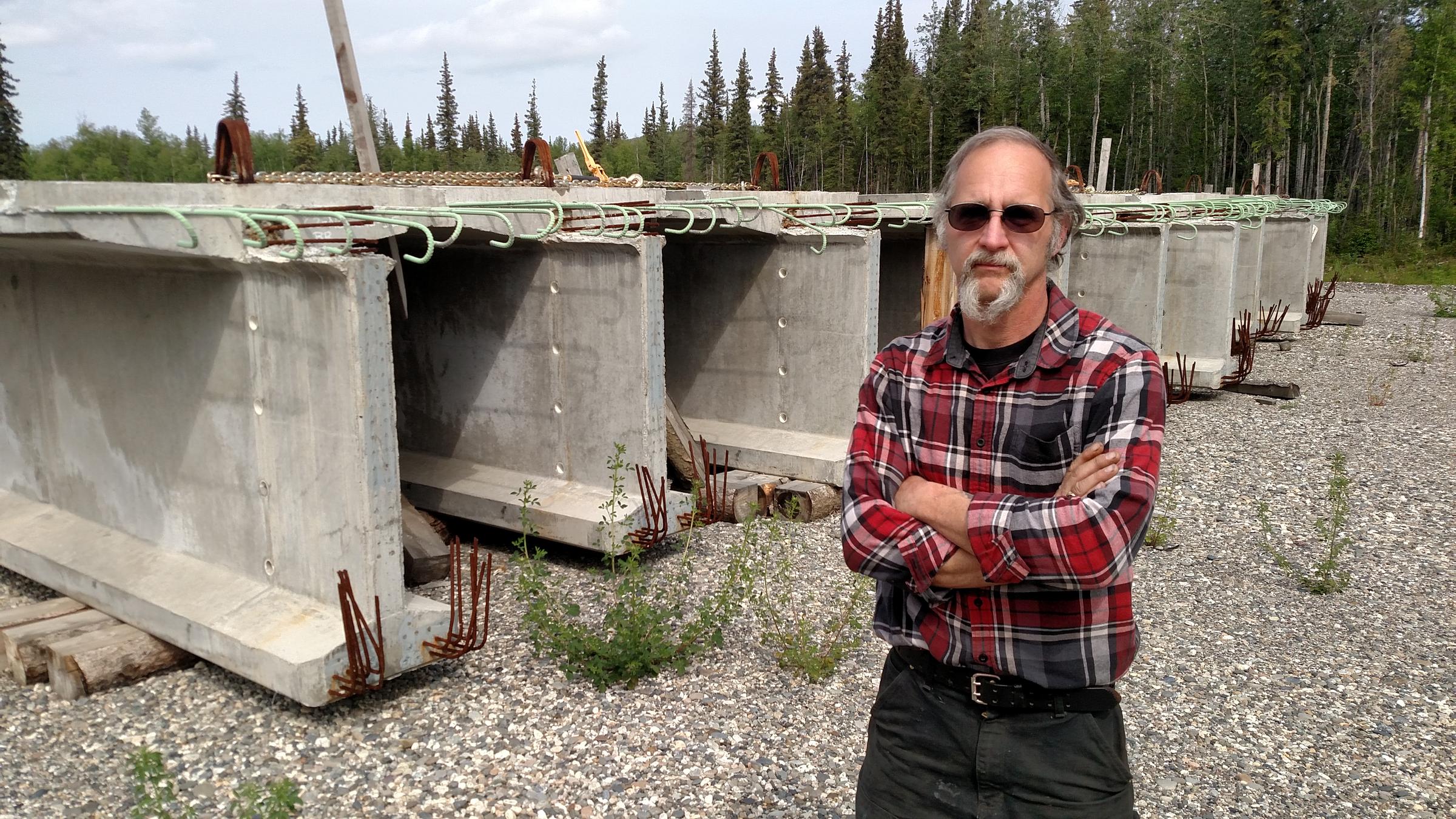 Nenana Mayor Jason Mayrand says the city has bought all the materials needed to build the Nenana River bridge, such as these enormous cast-concrete girders, and stockpiled them near the construction site. (Photo by Tim Ellis, KUAC - Fairbanks)