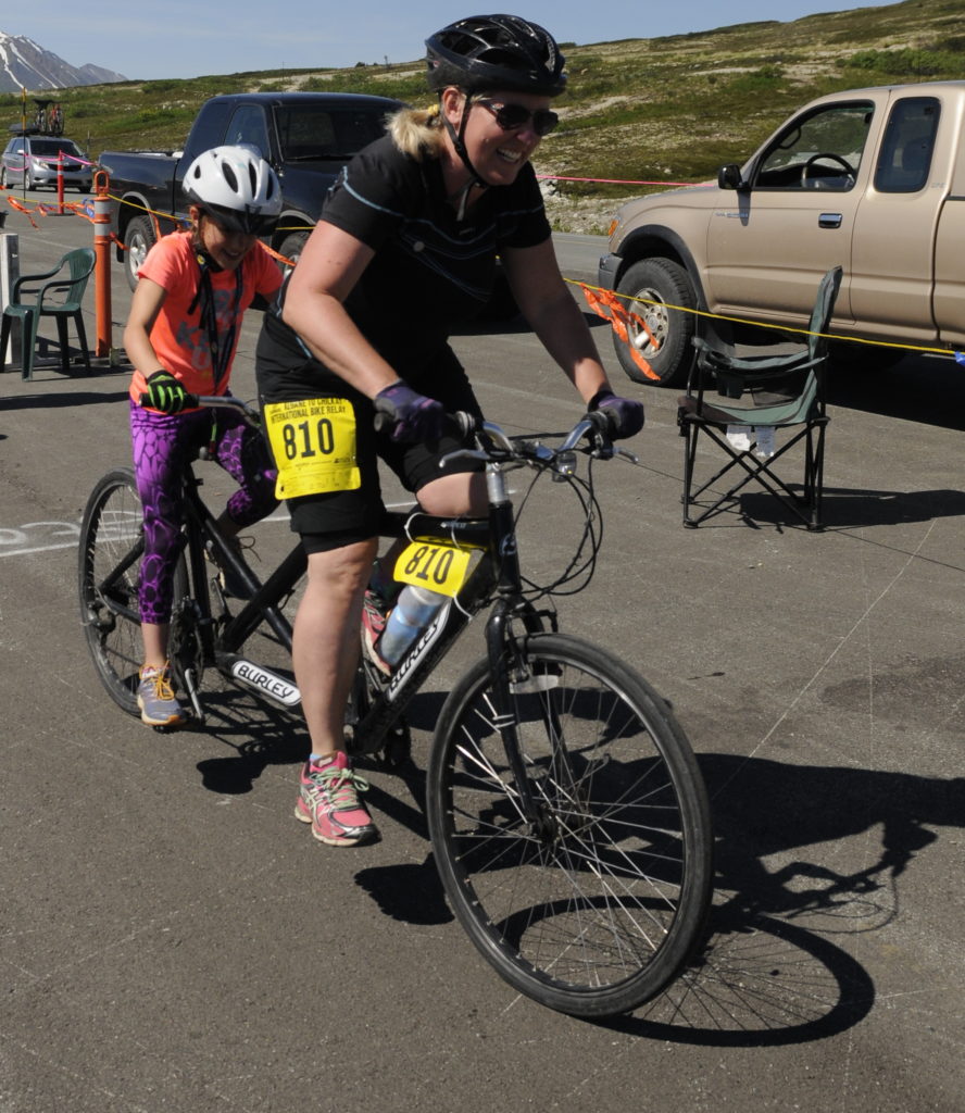 A tandem team takes off at the Haines Summit checkpoint during Saturday’s Kluane-Chilkat International Bike Relay. (Photo by Jillian Rogers, KHNS - Haines)