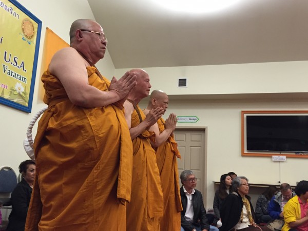 Three new monks wait for questions during the first official Buddhist monk ordination in Alaska. (Hillman/KSKA)