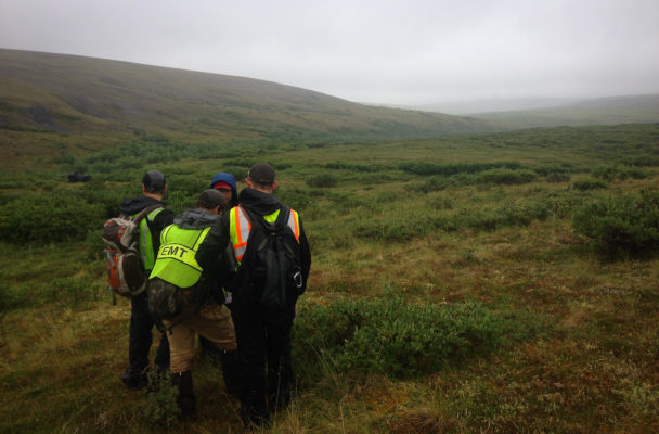 Members of the final day’s search crew reviewing a map of the area. (Photo by Emily Russell, KNOM - Nome)
