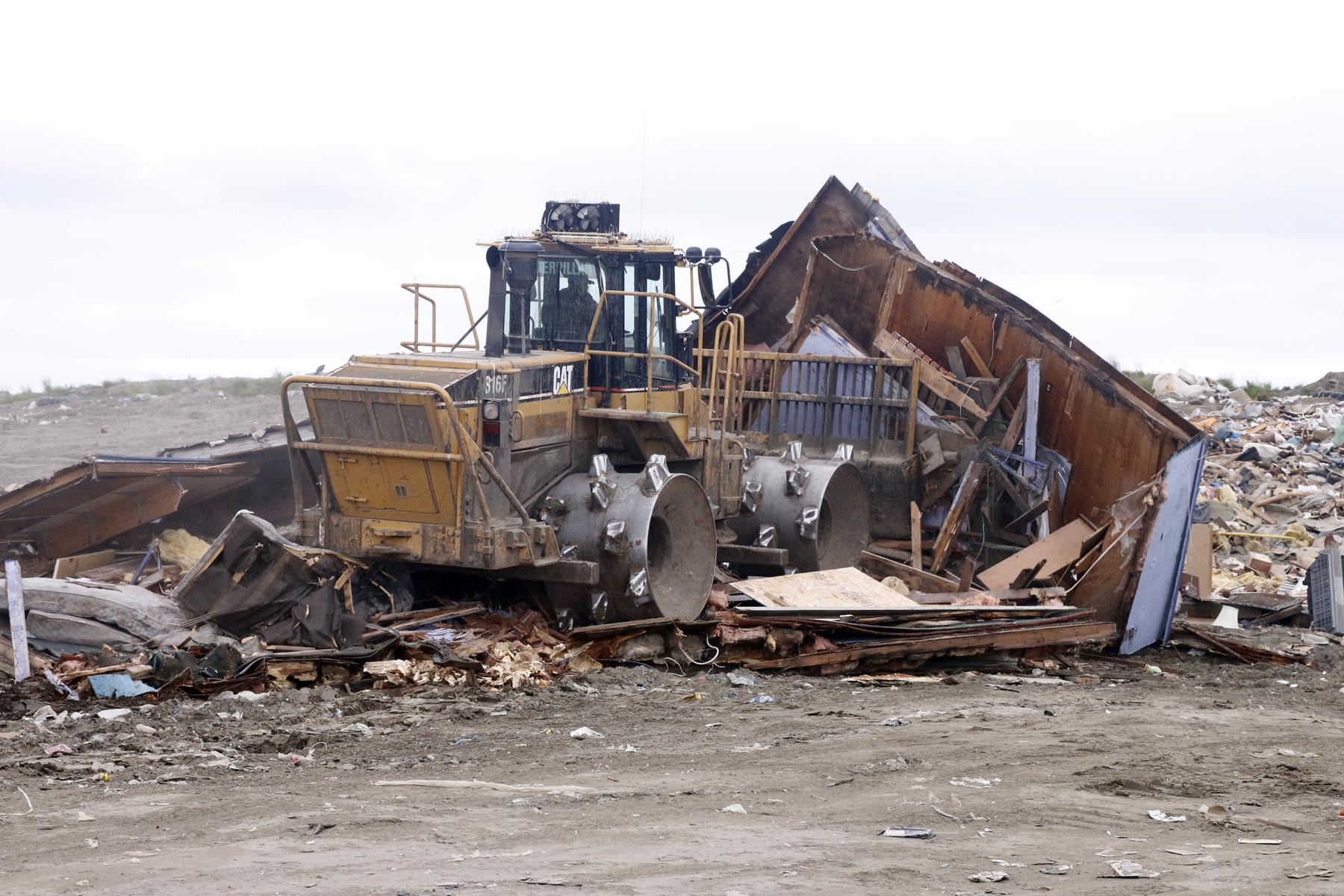 David Stovner, landfill manager, pushing debris (Photo by Dean Swope, KYUK - Bethel)