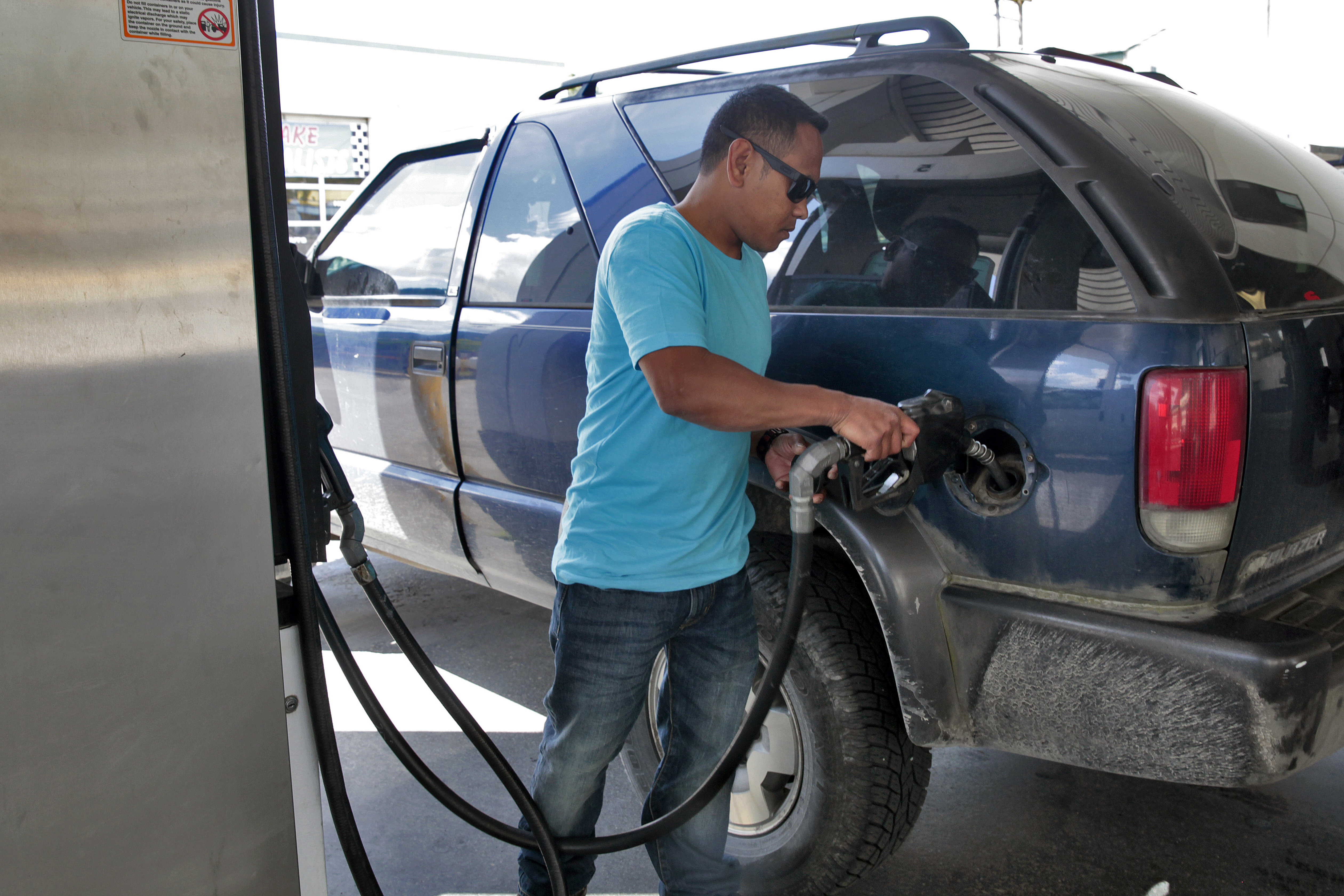 Richard Carrillo, of Juneau, gases up his suburban on July 7, 2016, in Juneau, Alaska. State economists said low energy prices caused a slower growth of inflation in Alaska last year. (Photo by Rashah McChesney, KTOO - Juneau)