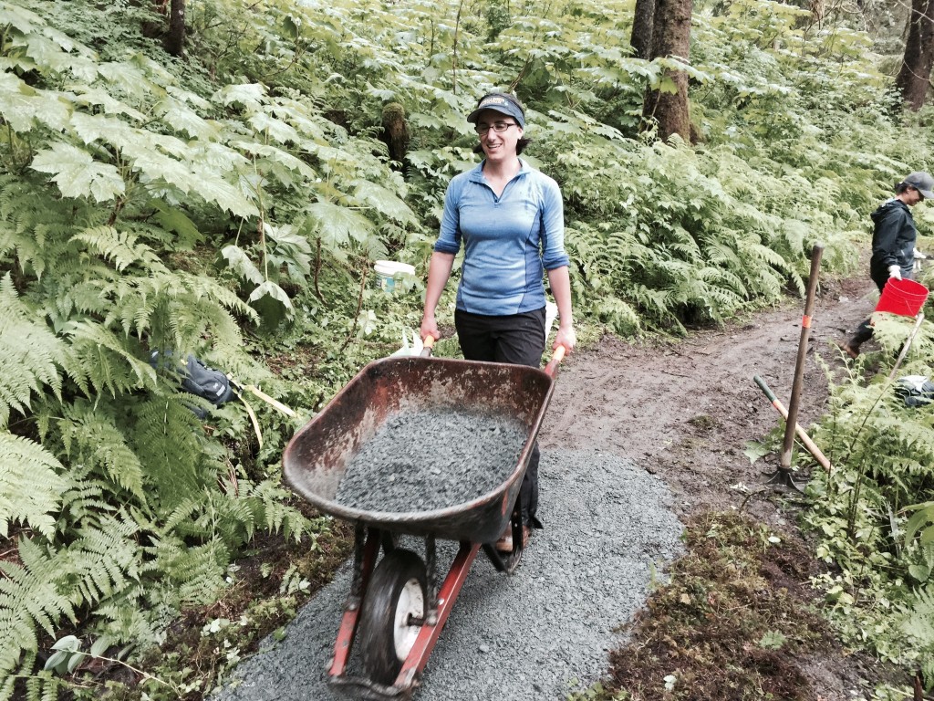 A Trail Mix volunteer moves gravel to a muddy part of Juneau’s Lemon Creek Trail. A new agreement means the nonprofit group will expand its work in Alaska’s national forests. (Photo courtesy Trail Mix)