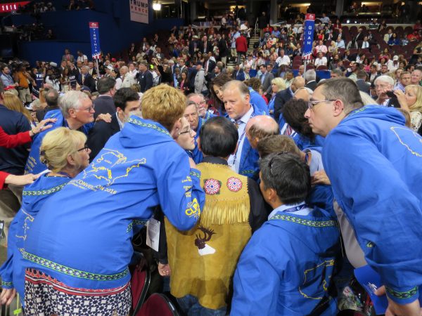 Alaska delegates huddle on the convention floor. Photo: Lawrence Ostrovsky.