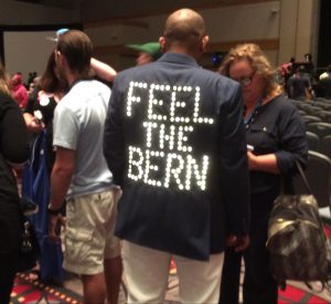 One Sanders fan stated his position in lights on his back. Photo: Liz Ruskin/Alaska Public Media