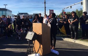 Neisha Jones reads the names of black police shooting victims during an event in midtown Anchorage. (Hillman/Alaska Public Media) 